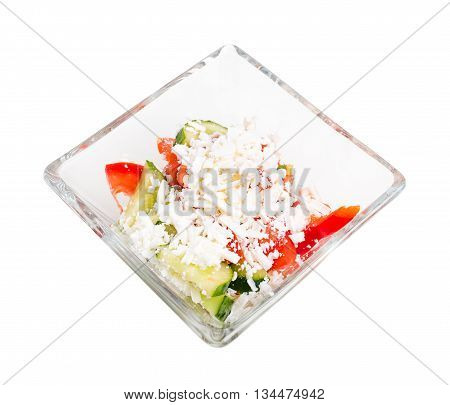 Traditional bulgarian salad shopski with fresh vegetables and grated sheep cheese. Isolated on a white background.