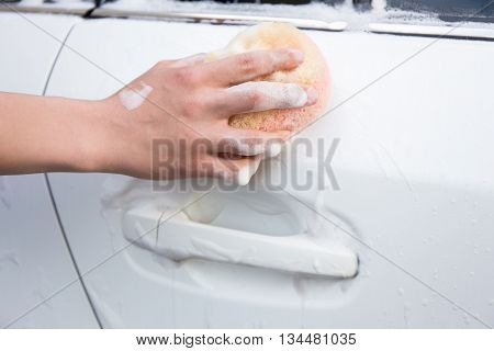 Handle Carwash Concept - Man Washing Car With Sponge