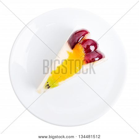 Creamy yougurt mousse cake with fruits on top. Isolated on a white background.
