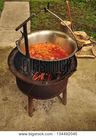 Traditional Goulash soup is boiling in the garden