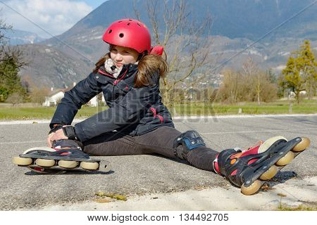 young attractive teenage skater grimacing in pain after taking a fall