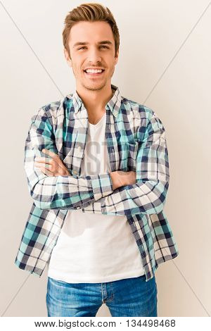 Portrait Of Cheerful Happy Man With Beaming Smile And Crossed Hands