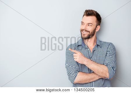Cheerful Handsome Man Showing Direction And Pointing With Finger