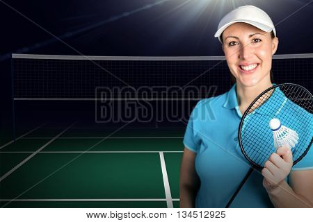 Composite image of badminton player holding badminton racket and shuttlecock against badminton field