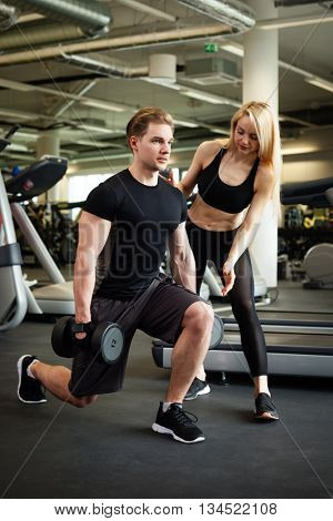 Fitness couple making exercies in a gym