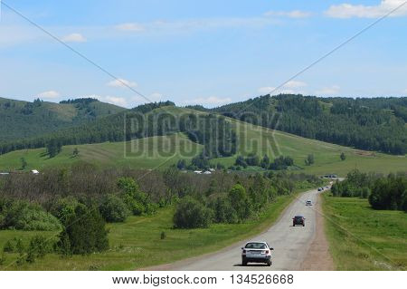 Country road with views of the mountains in summer