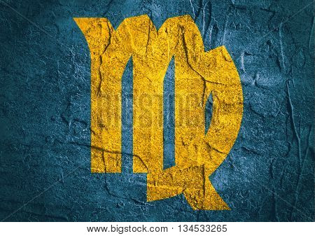 Maiden astrology sign. Yellow astrological symbol on concrete textured backdrop