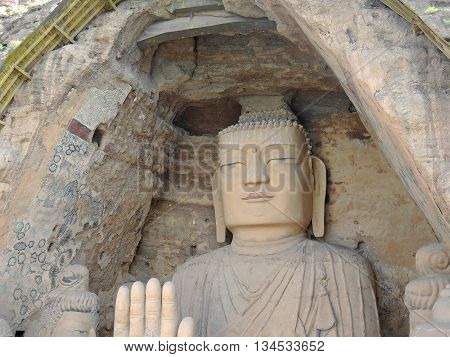 The 28 m Giant Buddha (Dafo) of buddhist cave complex Tiantishan (Tiantishan Grottoes) is located approximately 55 km south-east of Wuwei (Gansu, China) on the rocky eastern shore of the Huangyang reservoir, 12 m below the water level.