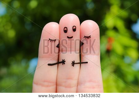 Finger art. Two women kissing a man.