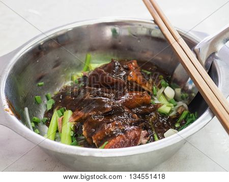 Close-up Of Noodle With Roast Duck In Stainless Steel Bowl And Spoon And Chopsticks
