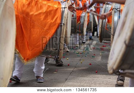 Traditional percussion instruments caled Dhol been played uring a Ganesh festival procession in India.