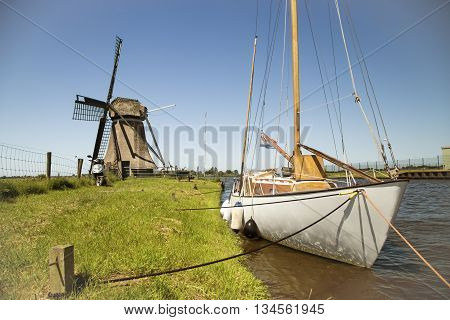 Yacht anchored near a winmill in Holland