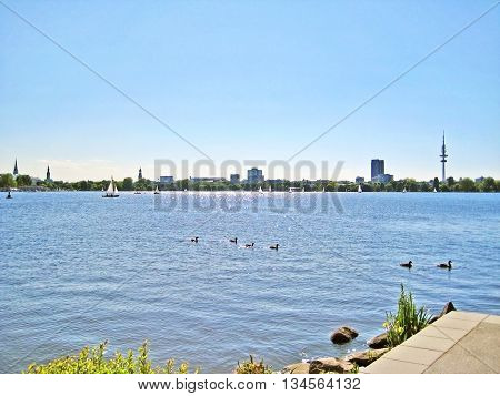 Hamburg lake Aussenalster with sailing boats - skyline of Hamburg city