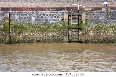 Quay with ladder and bolder in the port of Rotterdam in the Netherlands