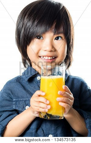 Close up portrait of small asian boy holding glass of fresh orange juice.Isolated on white background.