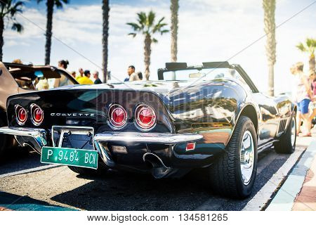 Benalmadena, Spain - June 21, 2015: A black Chevrolet Corvette C3 back viewed, parked in the port of Benalmadena (Spain), on June 21, 2015.