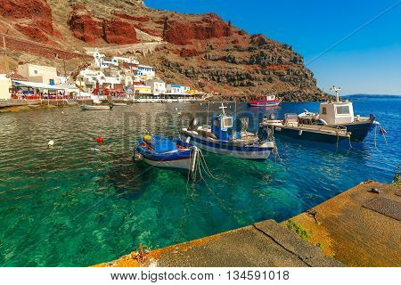 Fishing boats at Old port Ammoudi of Oia village at Santorini island in Aegean sea, Greece