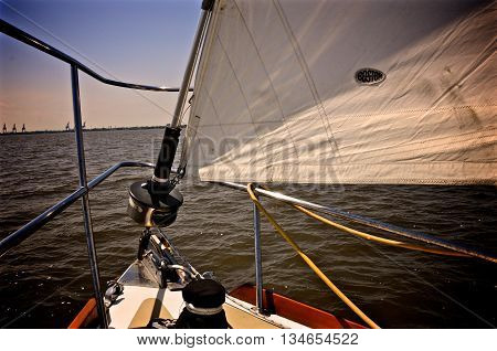 The bow of a sail boat with the sails raised