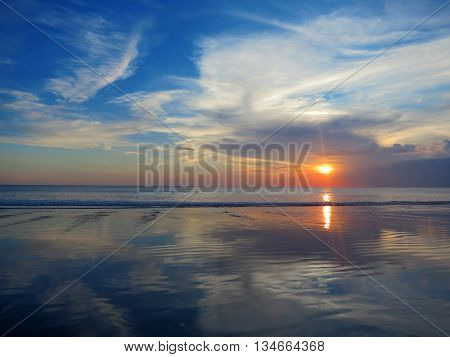 Beautiful sunset sky with reflection at Kuta and Seminyak beach, Bali