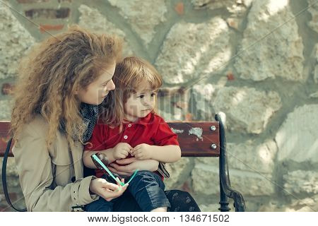 Little Boy And Woman On The Bench