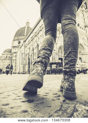 florence italy woman legs in jeans walking near the Santa Maria del Fiore cathedral in the square duommo monochrome