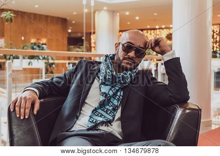 Arab businessman sitting on a sofa in an expensive hotel