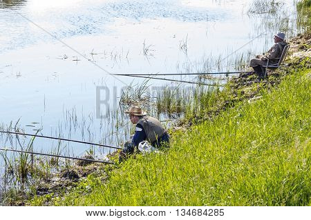 The river Kargat Novosibirsk oblast Siberia Russia - June 12 2016: a fisherman catches a fish on the river on a float