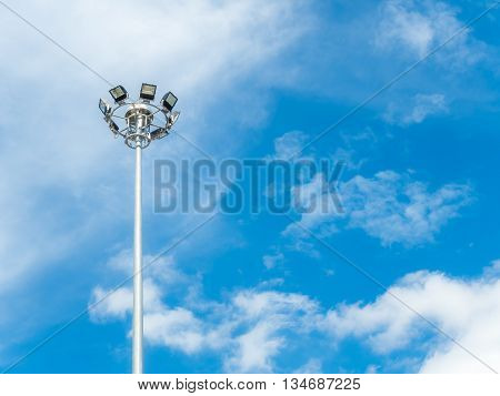 High voltage spotlight pole for sport stadium or street round by cloud and blue sky background
