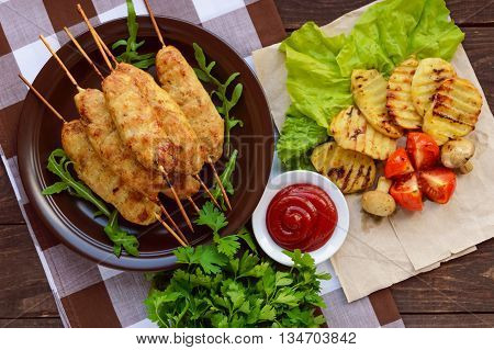 Grilled meat on a skewer - lula kebab. The traditional dish of the Caucasus Central Asia and Turkey. Grilled vegetables.The top view