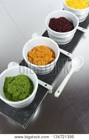 Healthy snacks - four colorful mousses from yellow paprika carrot red beet spinach