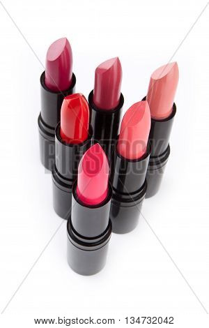 composition of colored lipsticks isolated on white background cosmetics