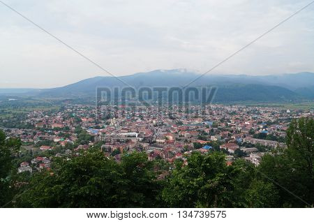 View of the city of Hust which is located near the mountains from the hill of the old castle ruins