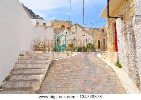 The narrow street with old houses in the historic part of Piskopiano Crete Greece.