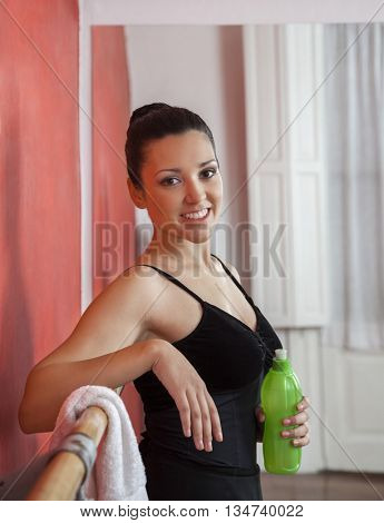 Confident Ballerina Holding Waterbottle In Dance Studio