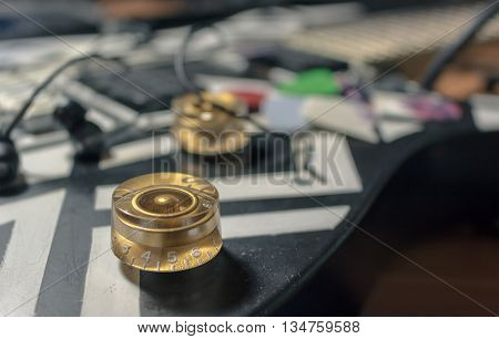 The volume controls and tone of an electric guitar