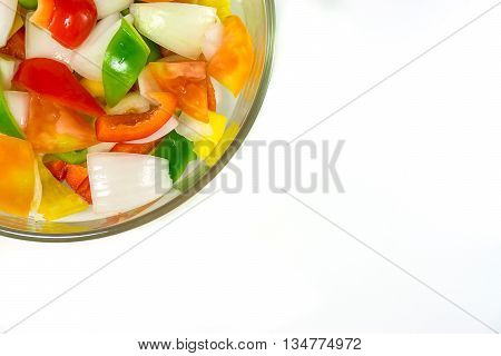 split tomatoes onion and sweet pappers in bowl