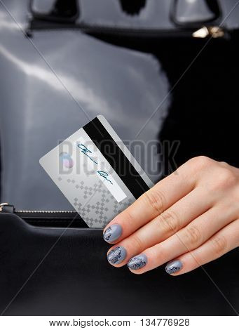Closeup of a credit card in a woman's hand