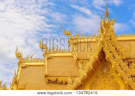 The gold roof of unique architecture in the Wat Rong Khun temple at Chiang Rai, Thailand.