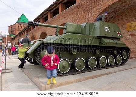 Nizhny Novgorod, Russia - May 3.2013. Children playing on the self-propelled artillery SU-76  at exhibition of military equipment of times of World War II in the Kremlin of Nizhny Novgorod.