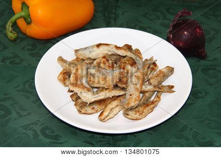 fried smelts Baltic fish on a dish on the tablecloth