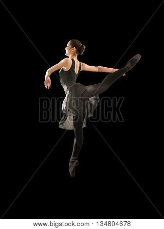 Young woman makes exercise isolated on black background