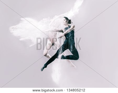 Two young women ballet dancing with flour in studio