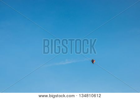 colorful hot air balloon in blue cloudy sky