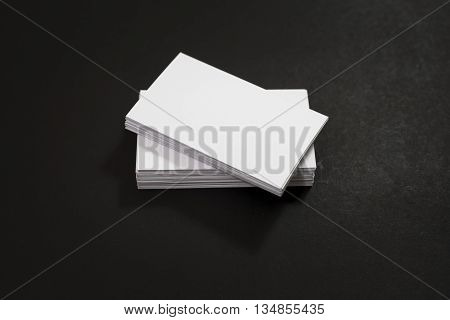 blank business cards stack up on Black background