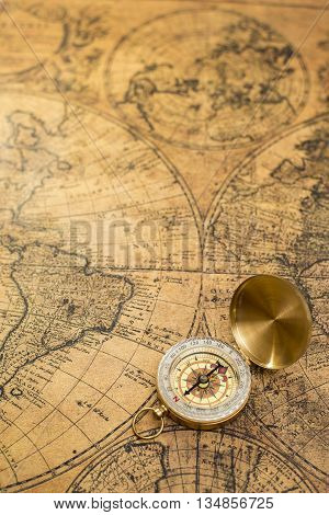 Beautiful old compass on vintage map background