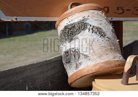 Mug with a lid made of birch bark in the outside shop