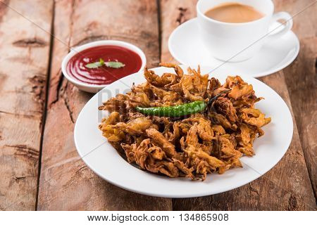 Samosa snack with tomato ketchup and hot tea, Fresh samosas with ketchup and hot chai ready for breakfast