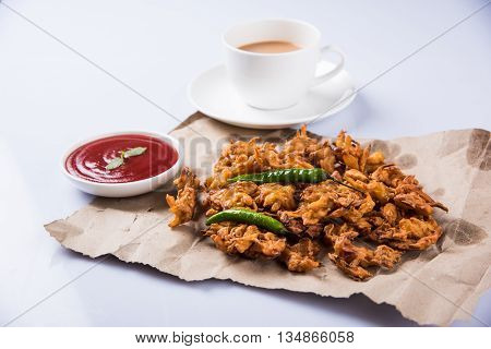 Samosa snack with tomato ketchup and hot tea, Fresh samosas with ketchup and hot chai ready for breakfast