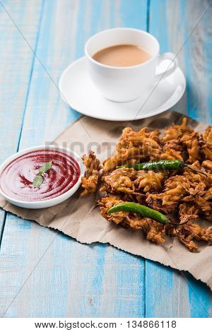 Samosa snack with tomato ketchup and hot tea, Fresh samosas with ketchup and hot chai ready for breakfast