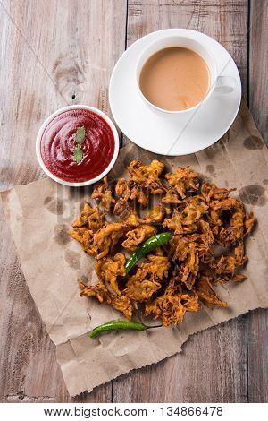 Samosa snack with tomato ketchup and hot tea, Fresh samosas with ketchup and hot chai ready for breakfast
